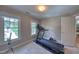 Workout room with a treadmill, weights, and bright windows with a view of the backyard at 405 Widdington Ln, Cary, NC 27519