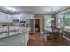 Kitchen with stainless steel appliances, granite countertops, white cabinets, and an eat-in dining area with natural light at 405 Widdington Ln, Cary, NC 27519