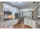 Modern kitchen featuring granite countertops, stainless steel appliances, white cabinets, and an adjoining dining area at 405 Widdington Ln, Cary, NC 27519