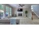 Inviting living room with a fireplace, large windows offering natural light, and staircase access to upper level at 405 Widdington Ln, Cary, NC 27519
