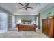 Spacious main bedroom with carpet flooring, ceiling fan, and tray ceiling at 405 Widdington Ln, Cary, NC 27519