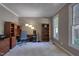 Comfortable and well-lit home office with a desk, chair, and shelving at 405 Widdington Ln, Cary, NC 27519