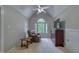 The sitting room has carpet flooring, a ceiling fan, and a view of the yard at 405 Widdington Ln, Cary, NC 27519