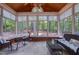 Bright sunroom with large windows, tile flooring, and comfortable seating, perfect for enjoying the outdoor view at 405 Widdington Ln, Cary, NC 27519