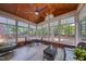 Inviting sunroom with abundant natural light, wood-paneled ceiling, tile floors, and cozy seating, perfect for relaxation at 405 Widdington Ln, Cary, NC 27519
