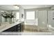 Bright bathroom features dual sinks, a soaking tub, and a glass-enclosed shower at 409 Falls Bluff Dr, Wake Forest, NC 27596