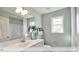 Bright bathroom with double sink vanity, white cabinets, and a combination shower and tub at 409 Falls Bluff Dr, Wake Forest, NC 27596