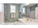 Neutral bath with single sink vanity, shower with patterned curtain, and small window at 409 Falls Bluff Dr, Wake Forest, NC 27596