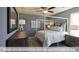 Stylish bedroom with a four-poster bed frame, soft lighting, and two dressers at 409 Falls Bluff Dr, Wake Forest, NC 27596