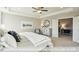 Bright, carpeted bedroom with tray ceiling, featuring abundant natural light from the windows at 409 Falls Bluff Dr, Wake Forest, NC 27596