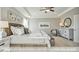 Bright bedroom showcasing tray ceiling, plush carpeting, and natural light coming through the windows at 409 Falls Bluff Dr, Wake Forest, NC 27596