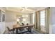 Dining room with coffered ceiling, modern chandelier, and large windows with patterned curtains at 409 Falls Bluff Dr, Wake Forest, NC 27596
