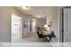 Bright hallway features neutral walls and flooring, with an adjacent study area and multiple rooms at 409 Falls Bluff Dr, Wake Forest, NC 27596