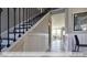 Bright hallway featuring stylish wall paneling and dark hardwood flooring at 409 Falls Bluff Dr, Wake Forest, NC 27596