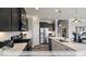 Modern kitchen with stainless steel appliances, white subway tile, and light countertops at 409 Falls Bluff Dr, Wake Forest, NC 27596
