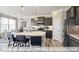 Open-concept kitchen with stainless steel appliances and spacious island with breakfast bar at 409 Falls Bluff Dr, Wake Forest, NC 27596