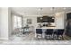 Open-concept kitchen with stainless steel appliances and spacious island with breakfast bar at 409 Falls Bluff Dr, Wake Forest, NC 27596
