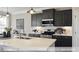 Modern kitchen with large island, stainless steel appliances, and stylish pendant lighting at 409 Falls Bluff Dr, Wake Forest, NC 27596