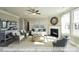 Bright living room with many windows, a fireplace, a ceiling fan and neutral decor at 409 Falls Bluff Dr, Wake Forest, NC 27596