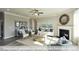 Bright living room with many windows, a fireplace, a ceiling fan and neutral decor at 409 Falls Bluff Dr, Wake Forest, NC 27596