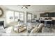 Bright living room opens to a kitchen, with hardwood floors and neutral decor at 409 Falls Bluff Dr, Wake Forest, NC 27596