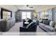 Spacious living room with ceiling fan, neutral decor, and a mounted TV at 409 Falls Bluff Dr, Wake Forest, NC 27596
