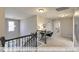Open loft area with desk space, carpet floors, and view of the laundry area at 409 Falls Bluff Dr, Wake Forest, NC 27596