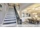 Elegant staircase with dark wood treads, white risers, and ornate iron railing at 409 Falls Bluff Dr, Wake Forest, NC 27596