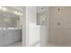 Contemporary bathroom featuring double sinks, sleek cabinets, and a glass-enclosed shower at 413 Falls Bluff Dr, Wake Forest, NC 27587