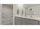 Bathroom featuring a double sink vanity, quartz countertops, and a bathtub shower combo at 413 Falls Bluff Dr, Wake Forest, NC 27587