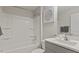 Clean bathroom features a shower-tub combo, sleek vanity, and modern fixtures, perfect for a refreshing experience at 413 Falls Bluff Dr, Wake Forest, NC 27587