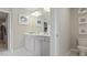 Bright bathroom featuring a double sink vanity with modern fixtures and artwork at 413 Falls Bluff Dr, Wake Forest, NC 27587