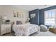 Charming bedroom features stylish décor, a comfortable bed, and a cozy seating area by the bright window at 413 Falls Bluff Dr, Wake Forest, NC 27587