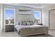 Well-lit bedroom with large windows, a comfortable bed, and matching nightstands at 413 Falls Bluff Dr, Wake Forest, NC 27587