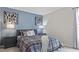 Cozy bedroom with a patterned duvet, bedside tables, and unique wall decor at 413 Falls Bluff Dr, Wake Forest, NC 27587