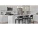 Bright kitchen features white cabinets, stainless appliances, and island seating at 413 Falls Bluff Dr, Wake Forest, NC 27587