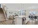 Open-concept living space with island seating and a fireplace at 413 Falls Bluff Dr, Wake Forest, NC 27587
