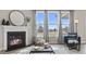 Bright living room with a fireplace, large windows offering scenic views, and comfortable seating at 413 Falls Bluff Dr, Wake Forest, NC 27587