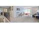 Spacious loft area, perfect for a home office or recreation, with large windows and carpeted flooring at 413 Falls Bluff Dr, Wake Forest, NC 27587