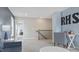 Cozy loft area with blue accent wall and adjacent to stairs at 413 Falls Bluff Dr, Wake Forest, NC 27587