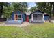 Backyard view with a blue home, screened porch, back deck, and lush green lawn at 418 Ridgefield Rd, Chapel Hill, NC 27517