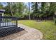 Landscaped backyard with a stone walkway, outdoor seating, and lush greenery at 418 Ridgefield Rd, Chapel Hill, NC 27517