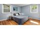Cozy bedroom with hardwood floors, natural light, and neutral decor at 418 Ridgefield Rd, Chapel Hill, NC 27517