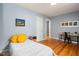 Bedroom featuring hardwood floors, a gray accent wall, and a desk at 418 Ridgefield Rd, Chapel Hill, NC 27517