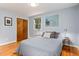Cozy bedroom featuring hardwood floors, a closet with wood doors, and soft gray walls at 418 Ridgefield Rd, Chapel Hill, NC 27517