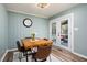 Dining room with wood table, chairs, and access to a screened-in porch at 418 Ridgefield Rd, Chapel Hill, NC 27517