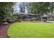 Charming blue home with mature trees, green lawn, and beautiful landscaping at 418 Ridgefield Rd, Chapel Hill, NC 27517