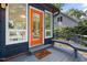 Home's welcoming entryway with a brightly colored door, side windows, and 'You're Here' welcome mat at 418 Ridgefield Rd, Chapel Hill, NC 27517