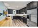 Modern kitchen with sleek, dark cabinets, stainless steel appliances, and light wood countertops at 418 Ridgefield Rd, Chapel Hill, NC 27517