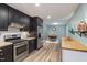 Open concept kitchen and dining area with stainless appliances and wood-look floors at 418 Ridgefield Rd, Chapel Hill, NC 27517
